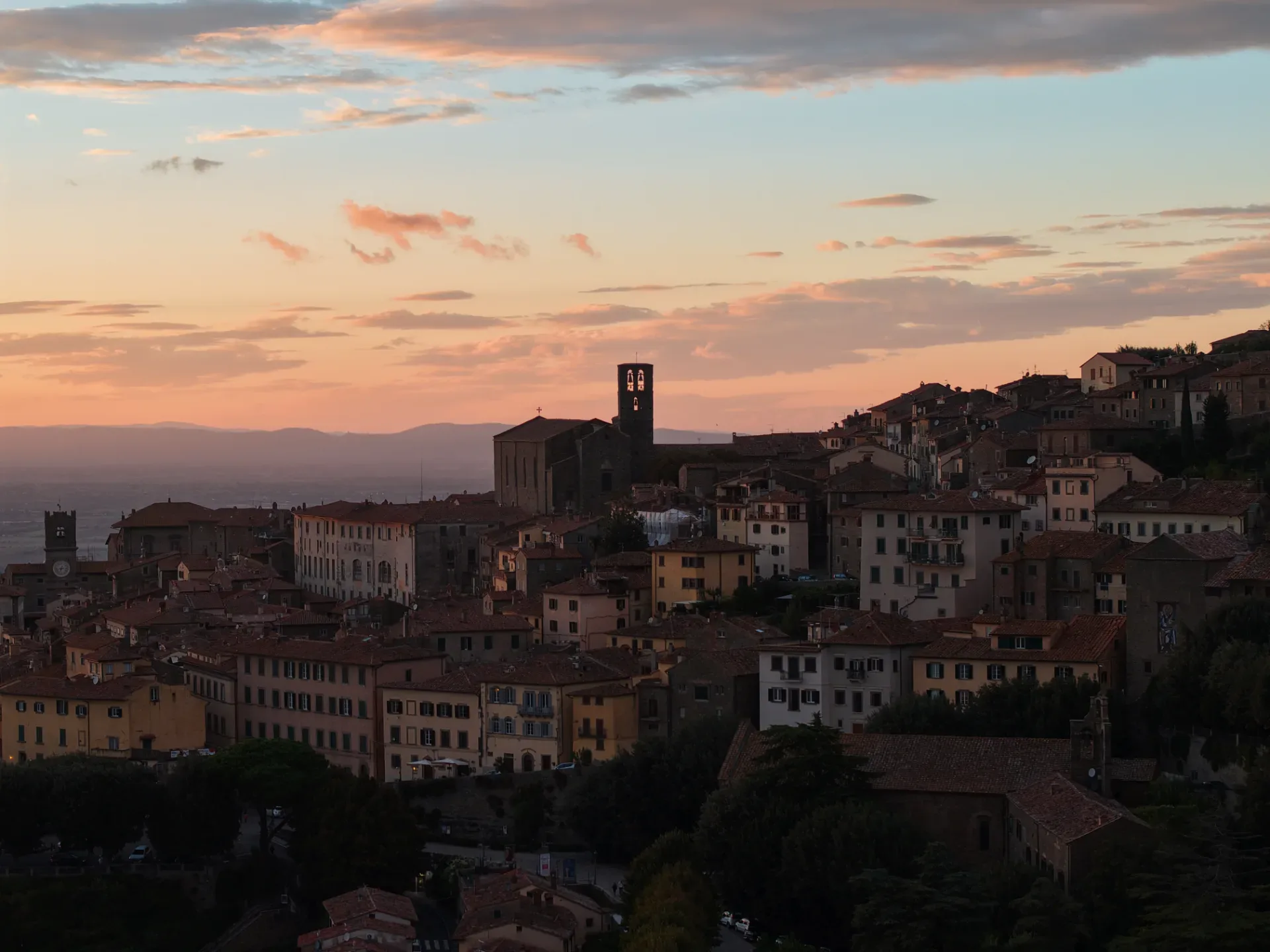 Panoramic view of Cortona hill town and its stone walls above the olive groves of the Valdichiana
