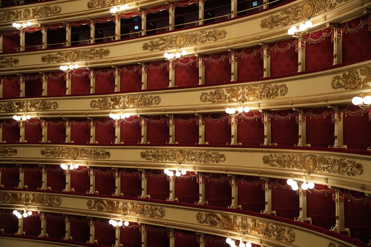 Interior of an Italian-style theatre, with the stalls and several tiers of boxes wrapping around the auditorium